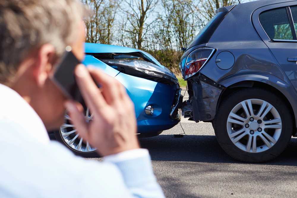 What Is a Traffic Collision Image of a driver making a phone call, featuring 411 Personal Injury Law, and highlighting the topic 'What Is a Traffic Collision?,' ensuring it aligns with the page's context on understanding traffic accidents and related legal aspects.